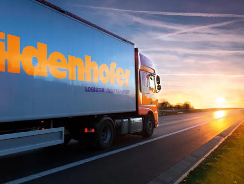 Spedition Wildenhofer LKW fährt in den Sonnenuntergang