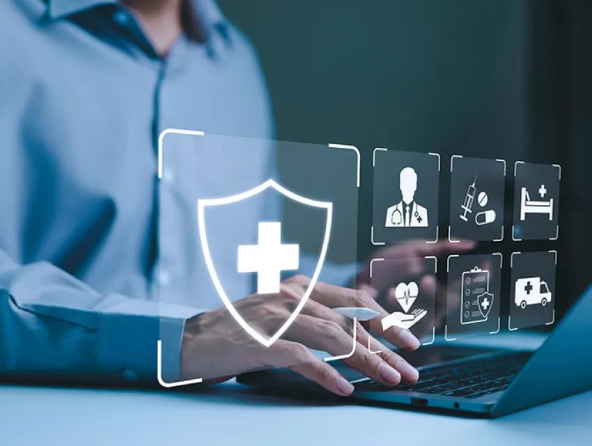 Bild zeigt Person am Laptop mit digitalen Gesundheitssymbole