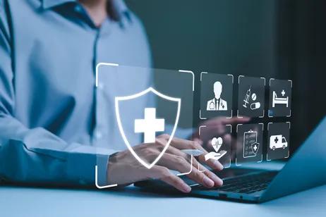 Bild zeigt Person am Laptop mit digitalen Gesundheitssymbole